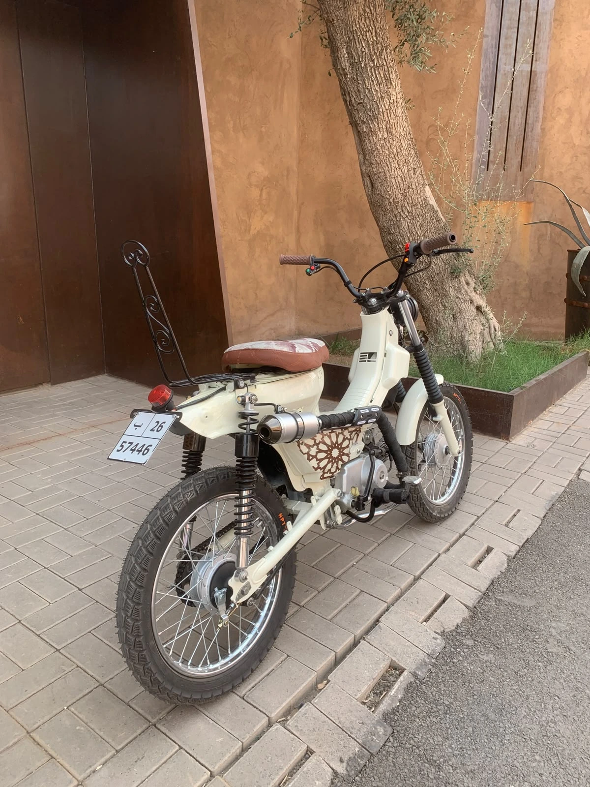 Rear view of the Mouad El Baraka custom motorcycle showing custom rack and patterned side panel