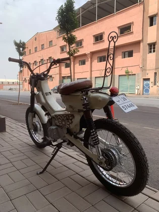 Rear three-quarter view of the Mouad El Baraka custom motorcycle on a Marrakech street thumbnail