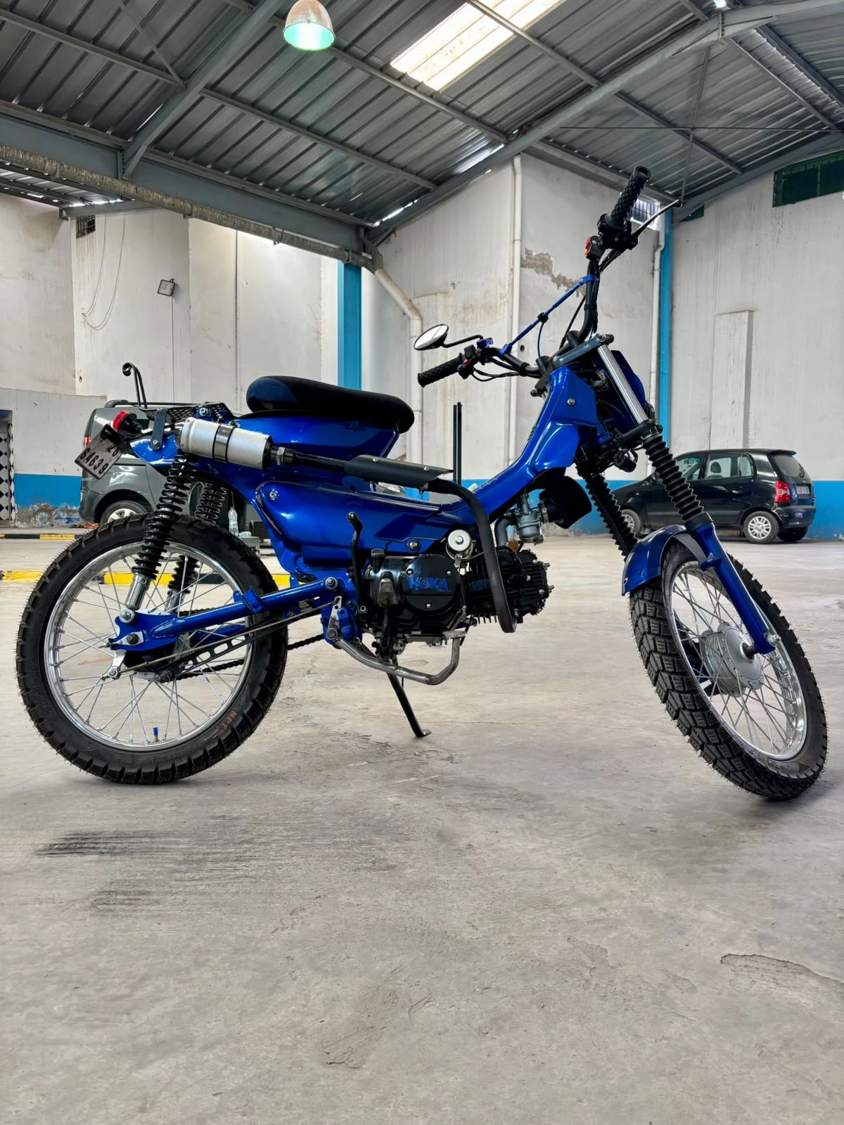 Sidi Bel Abbes custom blue motorcycle side view inside the BCE workshop