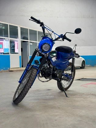 Sidi Bel Abbes custom blue motorcycle angled front view inside the BCE workshop thumbnail