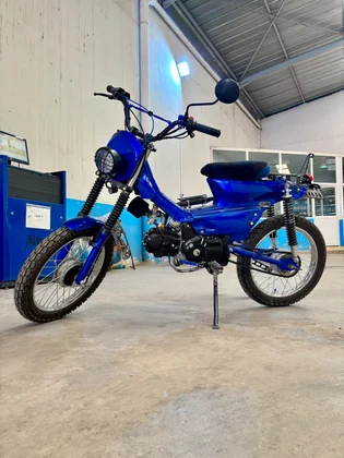 Sidi Bel Abbes custom blue motorcycle full side view inside the BCE workshop thumbnail
