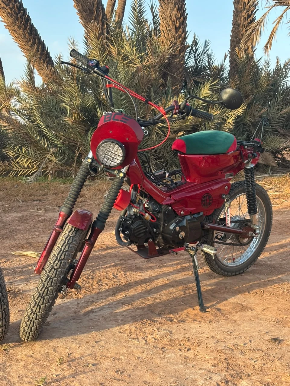 Sidi Youssef Ben Ali custom red motorcycle among palm trees in Marrakech