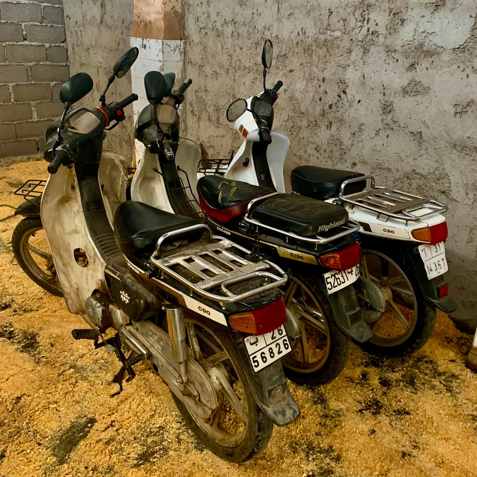 Group of original Honda Super Cub C90 donor motorcycles before custom rebuild
