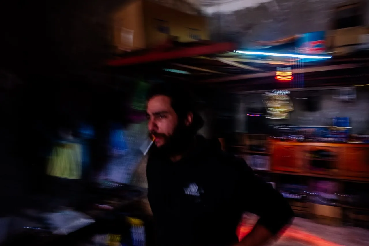 Motion-blur portrait of the creator inside the workshop at night