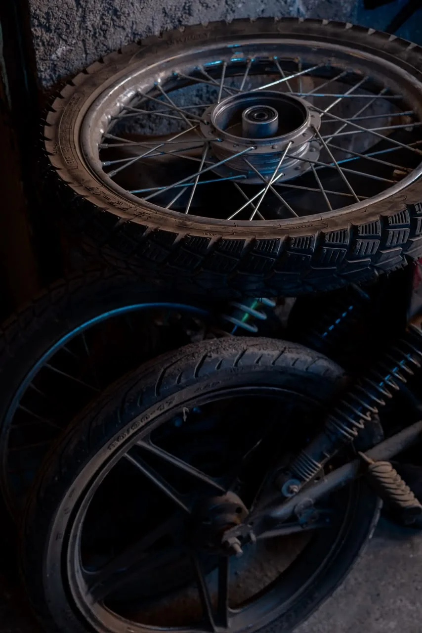 Stacked motorcycle wheels inside the workshop