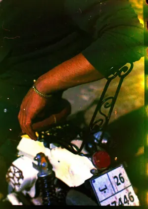 Close-up of the creator resting his hand on the rear section of a custom motorcycle thumbnail