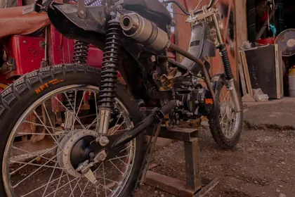 Three-quarter rear view of a custom motorcycle outside the workshop thumbnail