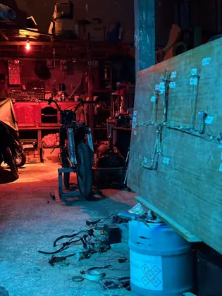 Workshop composition with a motorcycle project and a large wiring board thumbnail
