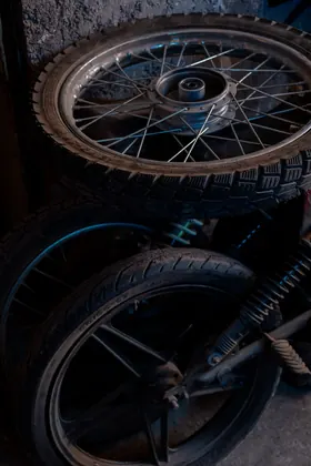 Stacked motorcycle wheels inside the workshop thumbnail