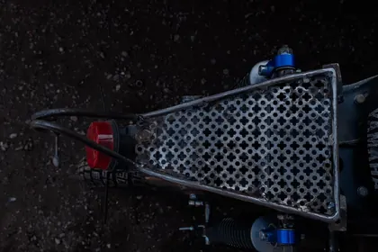 Top-down detail of the perforated rear rack on a custom motorcycle thumbnail